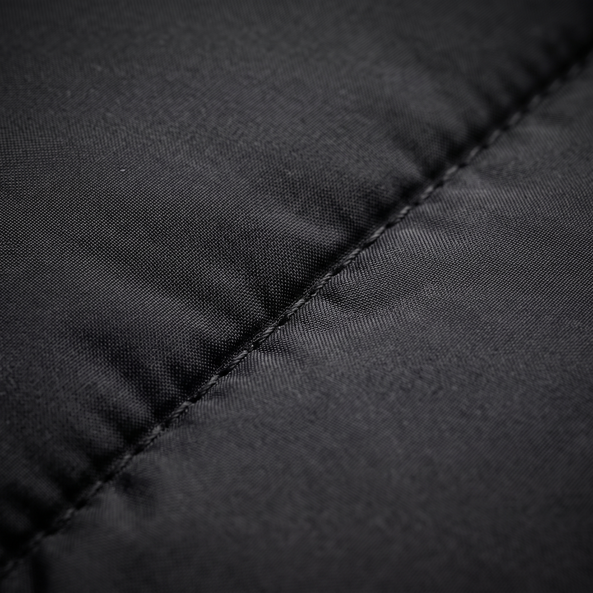 Black puffer jacket quilted nylon fabric macro